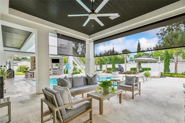 view of patio / terrace featuring ceiling fan, an outdoor hangout area, and a fenced in pool