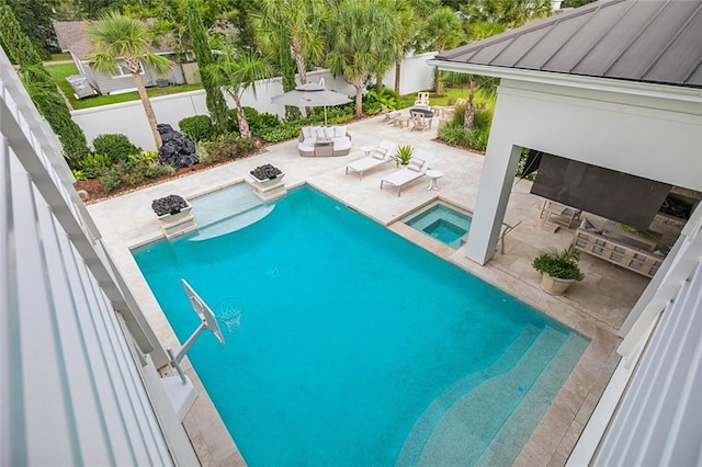 view of pool featuring a patio area and an in ground hot tub