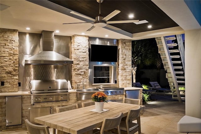 interior space featuring grilling area, an outdoor kitchen, sink, and ceiling fan