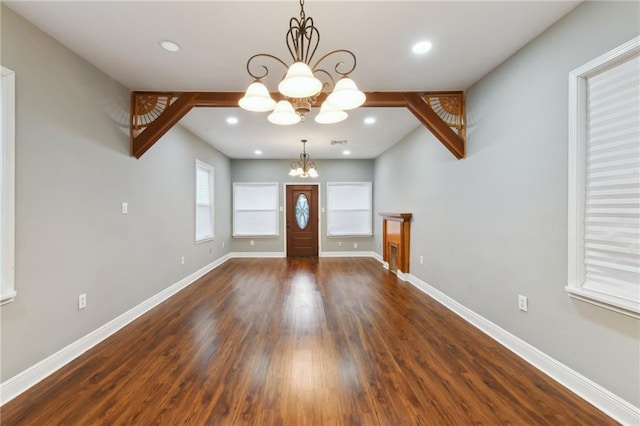 entrance foyer with a chandelier and dark hardwood / wood-style flooring