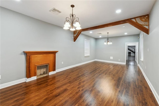 unfurnished living room featuring dark wood-type flooring and a chandelier