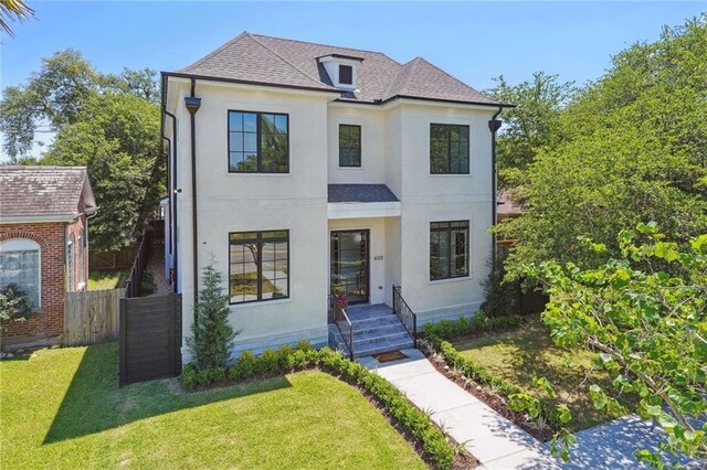 french provincial home featuring a front yard