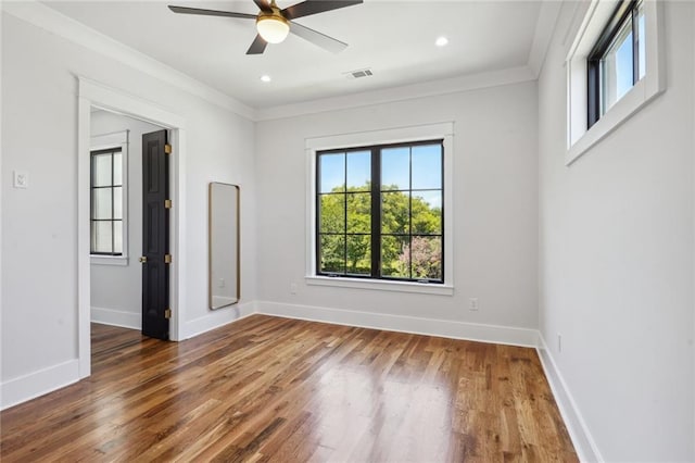 empty room featuring ceiling fan, ornamental molding, and dark hardwood / wood-style flooring