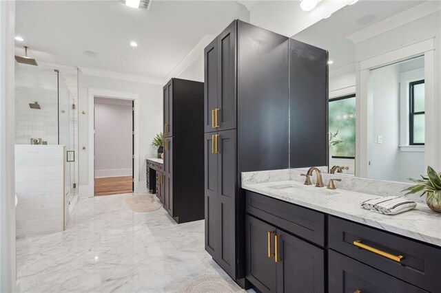 bathroom with ornamental molding, vanity, and an enclosed shower