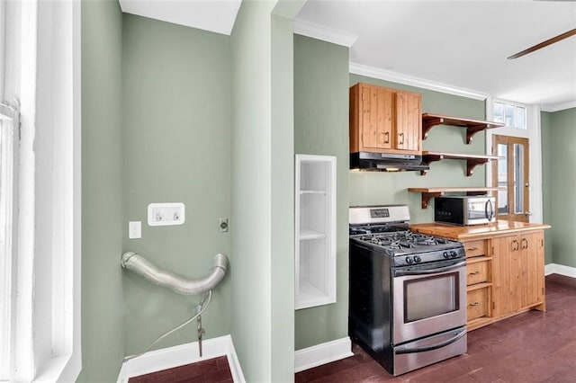 kitchen featuring dark wood-type flooring, ornamental molding, and appliances with stainless steel finishes