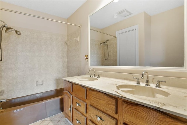 bathroom with shower / tub combination, tile patterned floors, and vanity