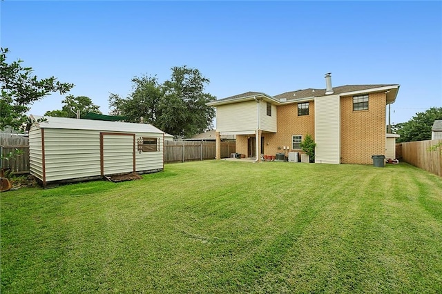 view of yard with a storage shed, a fenced backyard, and an outdoor structure