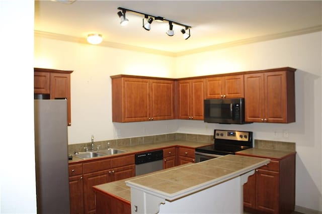 kitchen with appliances with stainless steel finishes, tile counters, ornamental molding, and sink