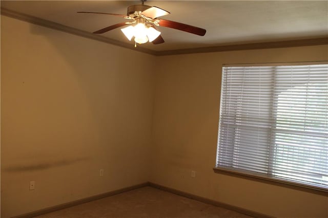 unfurnished room featuring ceiling fan and crown molding