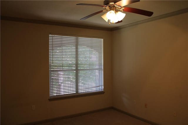 unfurnished room featuring ceiling fan and ornamental molding