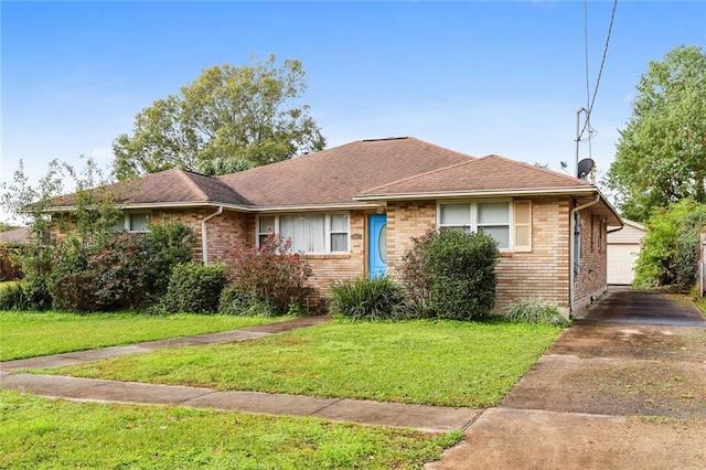 view of front of property with a garage and a front lawn