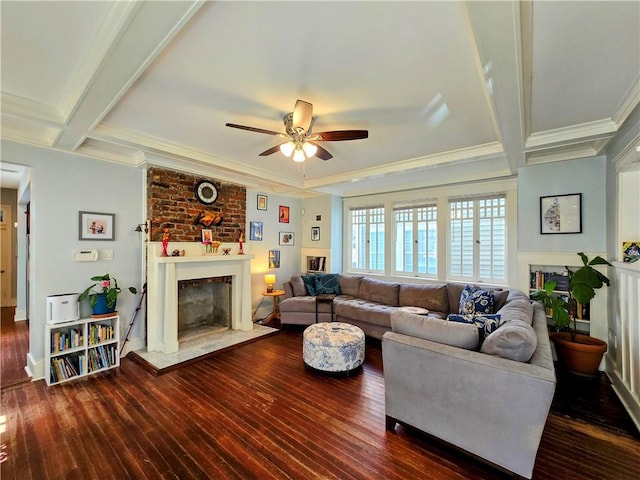 living room featuring ceiling fan, ornamental molding, beamed ceiling, and dark hardwood / wood-style flooring