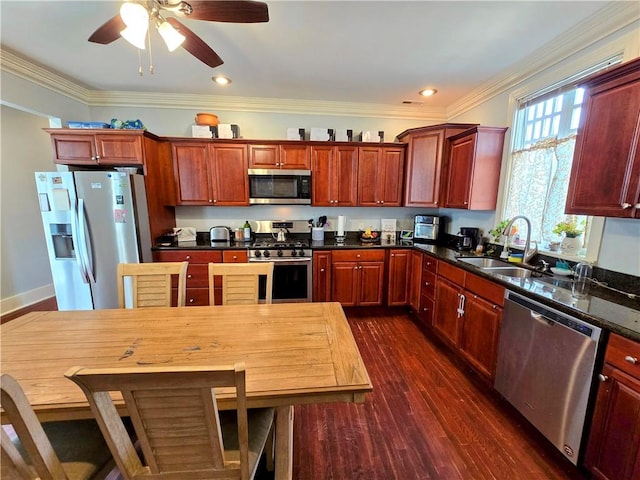 kitchen with ceiling fan, dark wood-type flooring, sink, stainless steel appliances, and ornamental molding