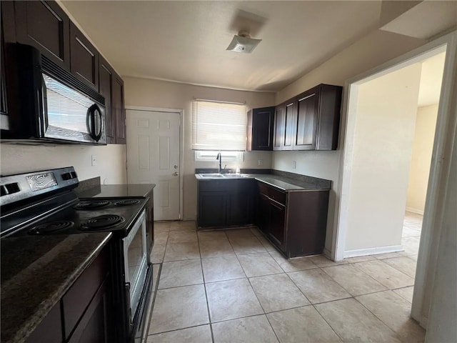 kitchen with light tile patterned floors, black appliances, sink, and dark brown cabinetry