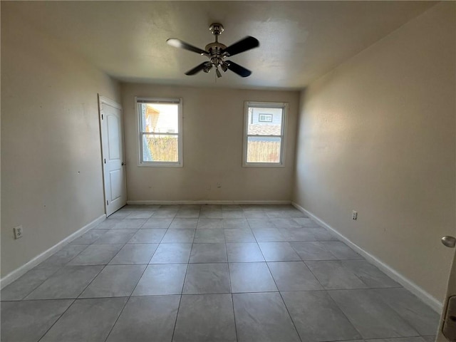 tiled empty room with ceiling fan