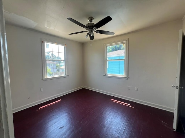 spare room featuring dark wood-type flooring and ceiling fan