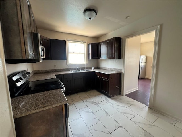 kitchen featuring stainless steel appliances, sink, and dark brown cabinetry