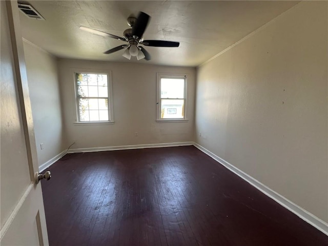 spare room featuring ceiling fan and dark hardwood / wood-style floors