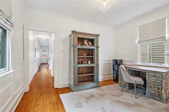 office with crown molding, light hardwood / wood-style flooring, and a wealth of natural light