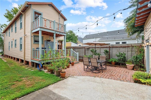 rear view of house with a balcony and a patio