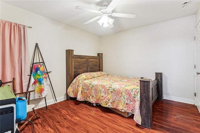 bedroom with ceiling fan and dark hardwood / wood-style floors