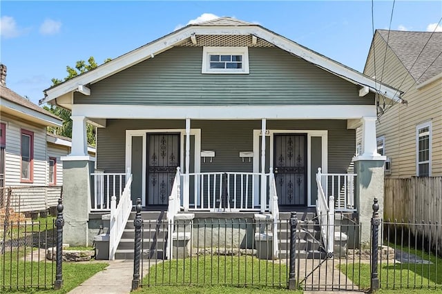 view of front of house with a porch and a fenced front yard