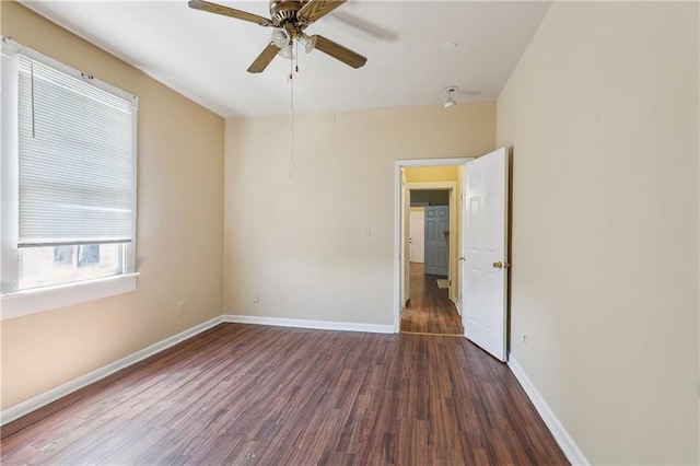 unfurnished room with baseboards, a ceiling fan, and wood finished floors