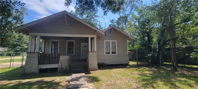 bungalow with covered porch and a front yard