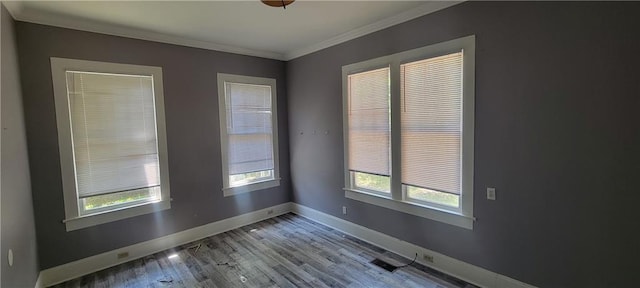 empty room featuring ornamental molding and wood-type flooring