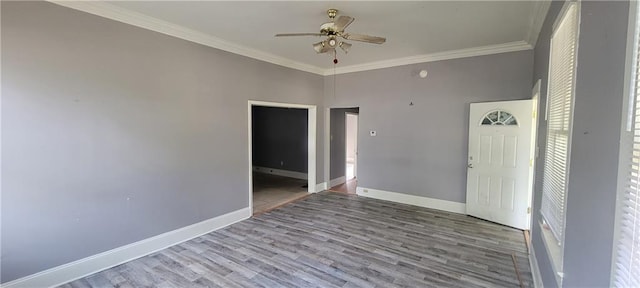 spare room with ceiling fan, hardwood / wood-style flooring, and crown molding