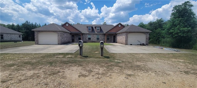 view of front of house featuring a garage and a front lawn