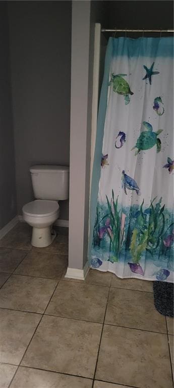 bathroom with toilet and tile patterned floors