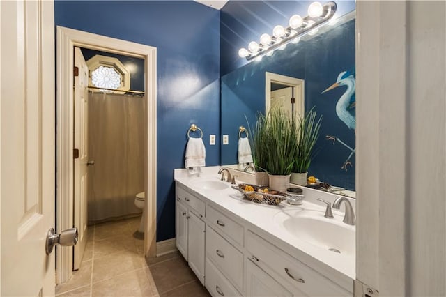 bathroom with vanity, walk in shower, tile patterned floors, and toilet