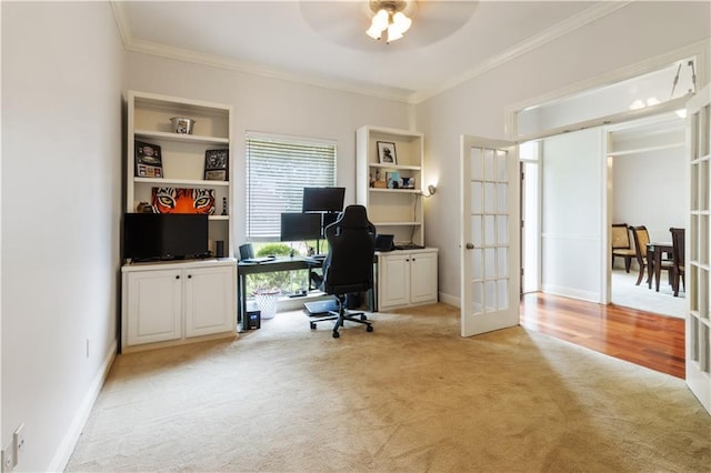 carpeted office space with crown molding, built in features, ceiling fan, and french doors