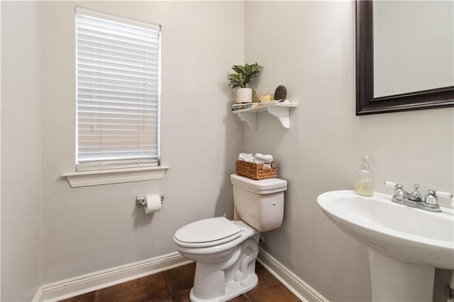 bathroom with sink, tile patterned floors, and toilet