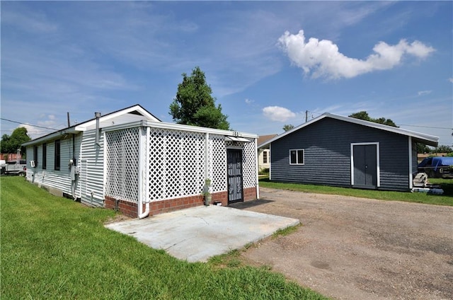 back of property featuring a yard and a patio area