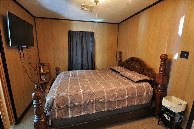 bedroom featuring light colored carpet, ornamental molding, and wooden walls