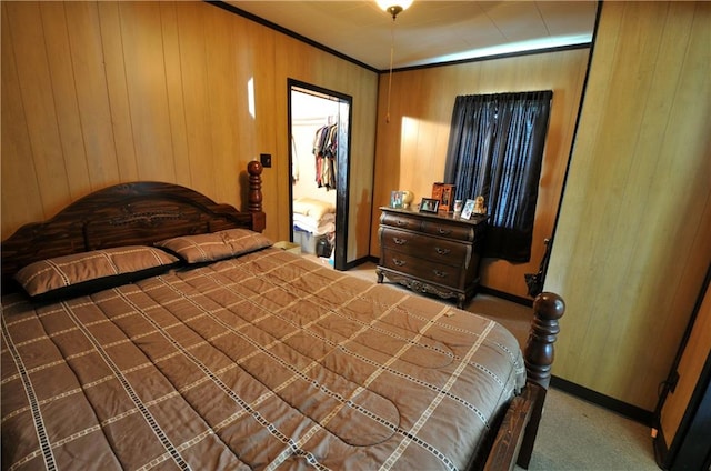 carpeted bedroom with wooden walls and a closet