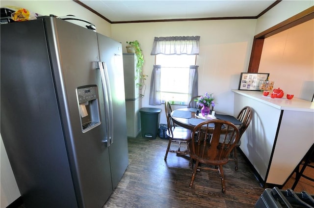 dining space with crown molding and dark hardwood / wood-style floors