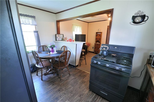 kitchen featuring ornamental molding, dark hardwood / wood-style flooring, and gas stove