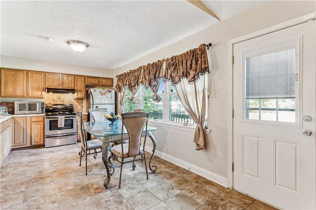 dining area featuring a textured ceiling