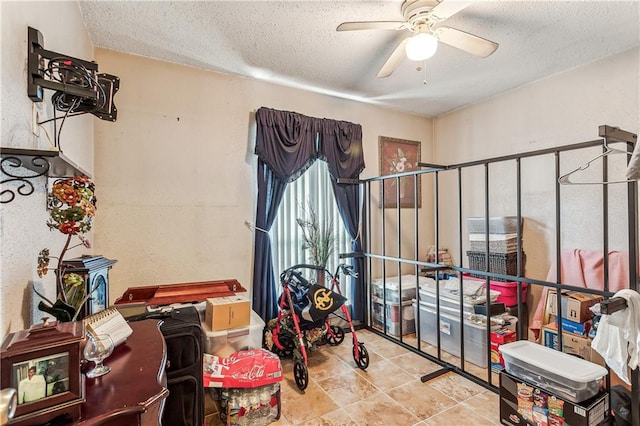 miscellaneous room featuring a textured ceiling, plenty of natural light, and ceiling fan