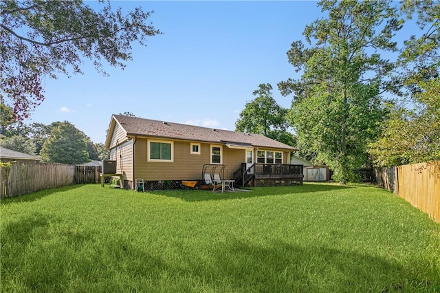 back of house with a yard and a deck