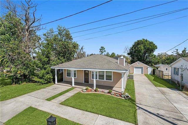 bungalow-style home with a front lawn, covered porch, and an outdoor structure