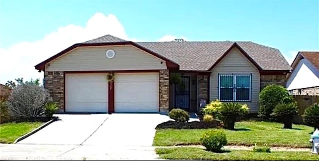 view of front of property featuring a garage and a front lawn