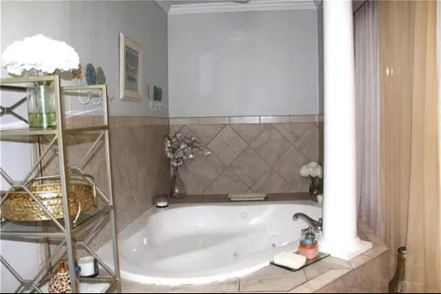 bathroom with crown molding, tiled tub, and ornate columns