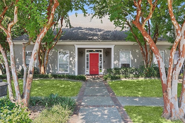 612 Hesper Ave, Metairie, LA 70005 - view of front facade with a front lawn, a shingled roof, and stucco siding