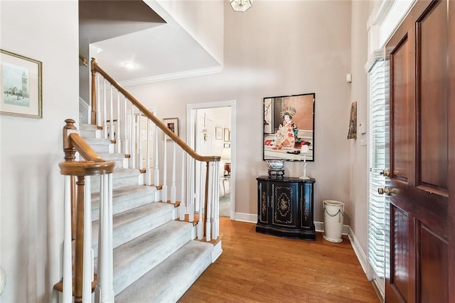 foyer with hardwood / wood-style floors and ornamental molding