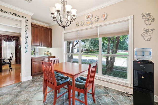 dining space featuring crown molding, hardwood / wood-style flooring, and a chandelier