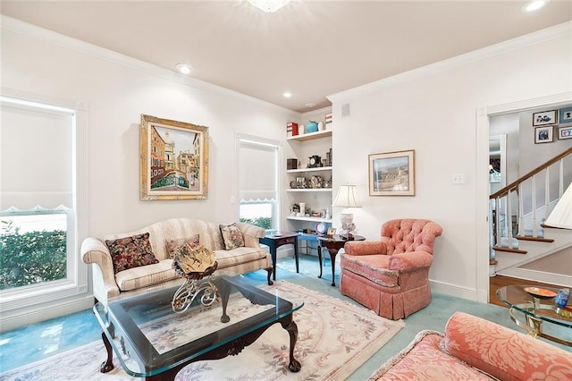 sitting room featuring built in shelves and crown molding